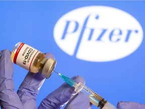 This file photo shows vial with COVID-19 vaccine stickers attached, with the logo of U.S. pharmaceutical company Pfizer.