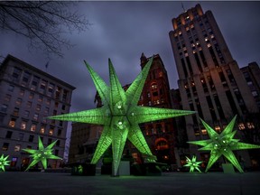 Holiday decorations light up at dusk in Place d"Armes in Old Montreal on Nov. 20, 2020.