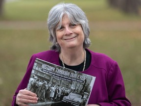 Montreal Gazette editorial page editor Edie Austin holds a copy of History Through Our Eyes in Montreal on Nov. 20, 2020. The photographs and vignettes published in 2019 have been collected in a large format book published by Véhicule Press.