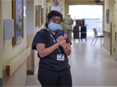 A staff member sanitizes her hands on the fifth floor at Maimonides.