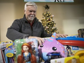 Welcome Hall Mission CEO Sam Watts with some of the Christmas gifts to be handed out on  the next three Mondays to needy kids, as part of Mission's annual Noel pour tous.