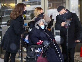 Sophie McCann, executive director of West Island Community Shares, left, with Stefanie Cadou and Matt Del Vecchio of Lianas Senior Transition Support, help set up an iPad for CHSLD Bayview resident Orysia Wywiorka outside the seniors' residence in Pointe-Claire, Wednesday.