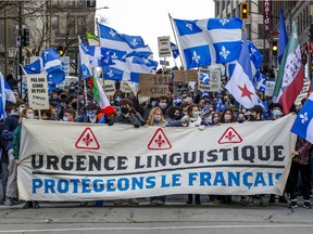 A demonstration by le Mouvement des jeunes souverainistes makes its way from Old Montreal to McGill's downtown campus in Montreal on Saturday, Nov. 28, 2020.