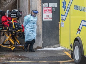 A resident is put into an ambulance at the rear of the Maimonides Geriatric Centre in Côte-St-Luc on Thursday, Nov. 26, 2020. The Family Advocacy Committee of Maimonides Geriatric Centre is calling for emergency measures to stop the spread of COVID-19 at the centre.