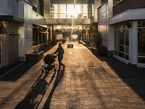 The setting sun casts long shadows at the Quartier Dix30 mall in Brossard on Tuesday November 24, 2020.