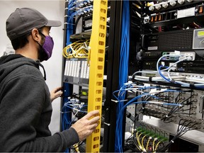 Pascal Gagnon-Renzetti, a radio frequency specialist for Telus, looks at one of the racks at a hub that controls the eastern section of the mobile phone network in the STM underground system.