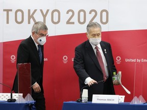 International Olympic Committee (IOC) President Thomas Bach (L) and President of the Tokyo 2020 Organising Committee Mori Yoshiro (R) arrive to attend a joint press conference between the IOC and Tokyo 2020 on November 16, 2020.