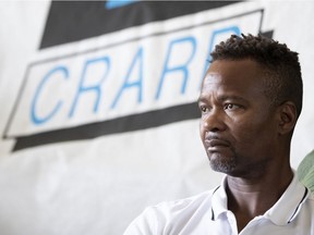 François Ducas listens as the story of his encounters with Repentigny police are told during a press conference at the Centre for Research-Action on Race Relations office in Montreal on July 10, 2019.