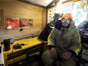 Louis Rouillard is working on his new home, a small trailer donated by a local garden centre. Rouillard is part of a tent city on Notre-Dame St.