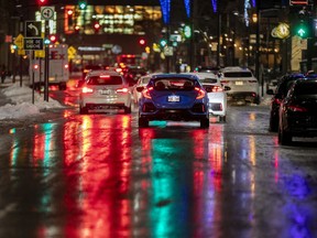 Traffic heads west on de Maisonneuve Blvd. on a wet day in Montreal Wednesday November 25, 2020.