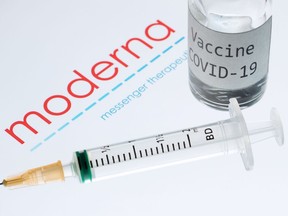 (FILES) This file photo taken on November 18, 2020 shows a syringe and a bottle reading "Vaccine Covid-19" next to the Moderna biotech company logo. - The European Union said on November 24, 2020 it would sign a sixth contract to reserve doses of an upcoming coronavirus vaccine, this time for up to 160 million from US giant Moderna.
