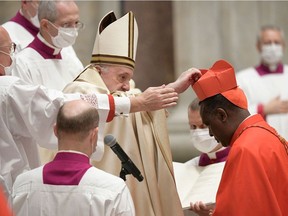 Rwandan Archbishop Antoine Kambanda receives his biretta after being named cardinal by Pope Francis at St. Peter's Basilica in the vatican.