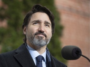 Prime Minister Justin Trudeau listens to a question from a reporter during a news conference outside Rideau Cottage in Ottawa, Friday, Nov. 27, 2020.