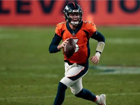 Denver Broncos quarterback Drew Lock scrambles with the ball against the Miami Dolphins in the fourth quarter at Empower Field in Denver on Nov. 22, 2020.