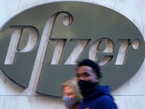 People walk past the Pfizer Headquarters building in the Manhattan borough of New York City, New York, U.S., November 9, 2020.