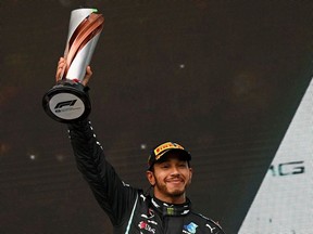 Winner Mercedes' British driver Lewis Hamilton celebrates on the podium after the Turkish Formula One Grand Prix at the Intercity Istanbul Park circuit in Istanbul on November 15, 2020.