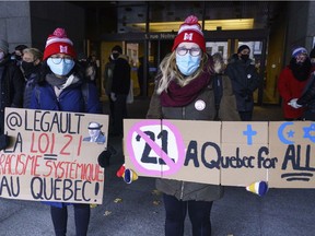 Demonstrators stand outside the courthouse on the first day of the constitutional challenge to Bill 21, which bans public workers in positions of "authority" from wearing religious symbols, before the Quebec Superior Court in Montreal on Monday, November 2, 2020.
