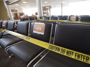 Seats in the waiting area of domestic departures lounge of Calgary International Airport are seen with caution tape on them on June 9, 2020. The Alberta government says rapid COVID-19 tests will soon be available at the Calgary airport and a United States border crossing so travellers coming into Canada don't have to quarantine for a full 14 days. The pilot project began Nov. 2 and is voluntary.