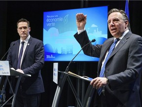 Quebec Premier François Legault announces his government's green plan flanked by Environment Minister Benoit Charette during a news conference in Montreal on Monday, Nov. 16, 2020.