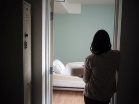 A staff member carries bedding in one of the suites at Toronto's Interval House, an emergency shelter for women in abusive situations, on Monday  February 6, 2017. A new national survey by Women's Shelters Canada offers a glimpse into the experiences of front-line workers and women fleeing violence during the COVID-19 pandemic, with reports of clients facing more violence that is also increasing in severity.