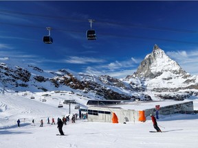 People ski with the Matterhorn mountain in the background, amid the coronavirus disease (COVID-19) outbreak, in the ski resort of Zermatt, Switzerland on Saturday, Nov. 21, 2020.