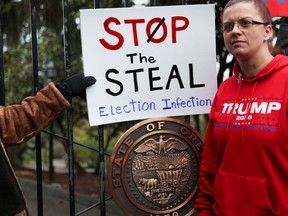 Supporters of U.S. President Donald Trump protest against restrictions put in place to limit the spread of coronavirus disease (COVID-19) and election results outside the governor's mansion, Mahonia Hall, in Salem, Ore., on Saturday, Nov. 21, 2020.