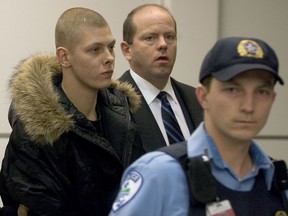 Sébastien Simon, left, is escorted by police officers in this January 2006 file photo.