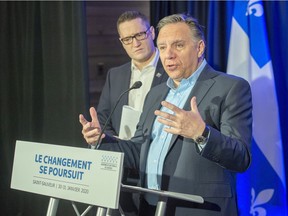 Quebec Premier Francois Legault speaks to the media as Environment Minister Benoit Charette looks on at a news conference last January.