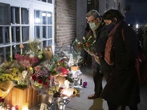 Quebec City Mayor Régis Labeaume brings flowers to a vigil to honour Suzanne Clermont, who was stabbed to death on Halloween night by a man with a sword.