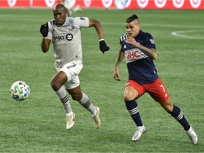 Montreal Impact defender Rod Fanni, left, and New England Revolution forward Gustavo Bou chase after the ball during the second half at Gillette Stadium in Foxborough, Mass., on Nov 20, 2020.
