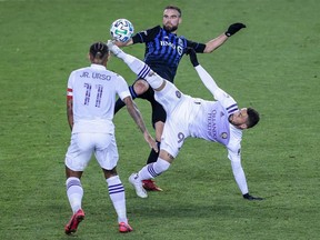 Orlando City forward Matheus Aias (99) kicks the ball as Montreal Impact defender Rudy Camacho (4) defends in front of midfielder Junior Urso (11) during the second half at Red Bull Arena Nov. 1, 2020.
