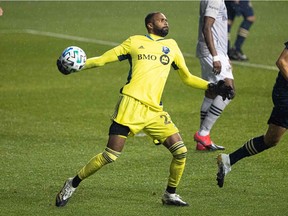 Montreal Impact goalkeeper Clement Diop throws the ball against the Philadelphia Union during the first half at Chester, Penn., on Oct. 11, 2020.