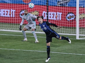 Impact defender Luis Binks heads the ball away from goalkeeper Clément Diop during game against Nashville SC at Red Bull Arena last month.