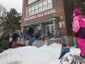 Parents wait in line outside Royal Vale School to get a chance to register their children at the coveted school in Notre-Dame-de-Grâce in Montreal on Sunday, February 5, 2017.