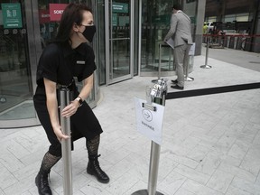 Staff at the Simons downtown prepare to reopen on May 25, 2020 after Premier François Legault lifted the pandemic lockdown.