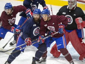 Canadiens' Jordan Weal, left, and Jake Evans create traffic for defenceman Shea Weber and goalie Carey Price during training camp practice at the Bell Sports Complex in Brossard on July 15, 2020.