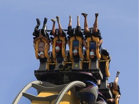 Masked people take a ride called the Vampire at La Ronde in Montreal Saturday, July 25, 2020.
