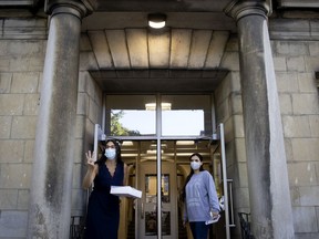 Staff members call Grade 3 students to enter for the first day of classes at Bancroft Elementary School in Montreal, on Monday, Aug. 31, 2020. Bancroft is one of the schools that will receive new air purifiers.