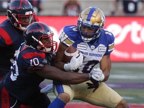 Montreal Alouettes' Henoc Muamba (10) and Tevin Floyd bring down Winnipeg Blue Bombers's Nic Demski in Montreal on Sept. 21, 2019.