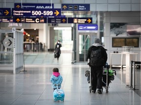 Nov. 18, 2020: A young traveller follows her father at a deserted Montreal Trudeau airport. Never had I seen so few people at the airport — parents had no worries about losing their kids.