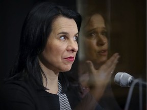 Montreal Mayor Valérie Plante listens as public health director Dr. Mylène Drouin, reflected in a plexiglass divider, speaks during a COVID-19 update Nov. 25, 2020.
