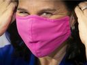 Montreal Mayor Valerie Plante puts on her mask following the unveiling of the city's new economic revitalization plan during the press conference at City Hall on Thursday, December 3, 2020. 