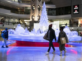 Shoppers walk through the shopping mall at Complexe Desjardins on Friday December 4, 2020.