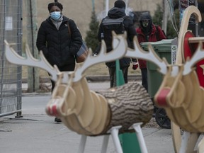 People make their way along Mont-Royal with its Christmas decorations on Dec. 8, 2020.