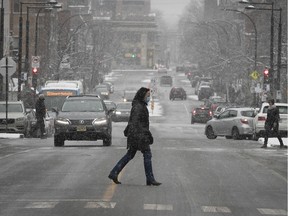 MONTREAL, QUE.: DECEMBER 9, 2020 --  With light snow falling a pedestrian crosses Laurier street near Durocher in Outremont on Wednesday December 9, 2020 during the COVID-19 pandemic. (Pierre Obendrauf / MONTREAL GAZETTE) ORG XMIT: 65475 - 6817