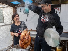 Randy Gibara and his mom Christine Ferris fry a 15-pound turkey at his home in Pierrefonds.