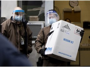 UPS drivers deliver the first box of COVID-19 vaccinations on Monday at Montreal’s Maimonides Geriatric Centre, a long-term care centre hit hard by the pandemic.