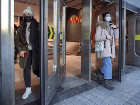 Masked transit users exit the Guy-Concordia metro station on Dec. 15, 2020.