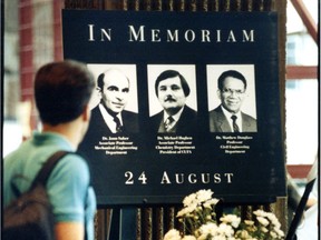 A man pauses in front of a makeshift memorial to Matthew Douglass, Michael Hogben and Jaan Saber, three of Valery Fabrikant's victims, in August 1992. A fourth victim, Phoivos Ziogas, died a month after being shot.