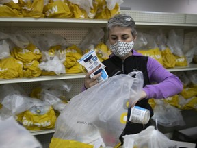 Sun Youth volunteer Josee Paradis prepares food baskets on Friday, December 18, 2020. “We’ve had to change basically everything from A to Z” because of the pandemic, spokesperson Ann St Arnaud said.